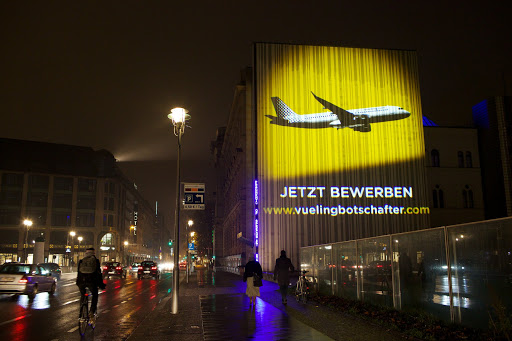 In this image Vueling leverages the unique guerrilla marketing technique of inserting a guerilla projection on a building